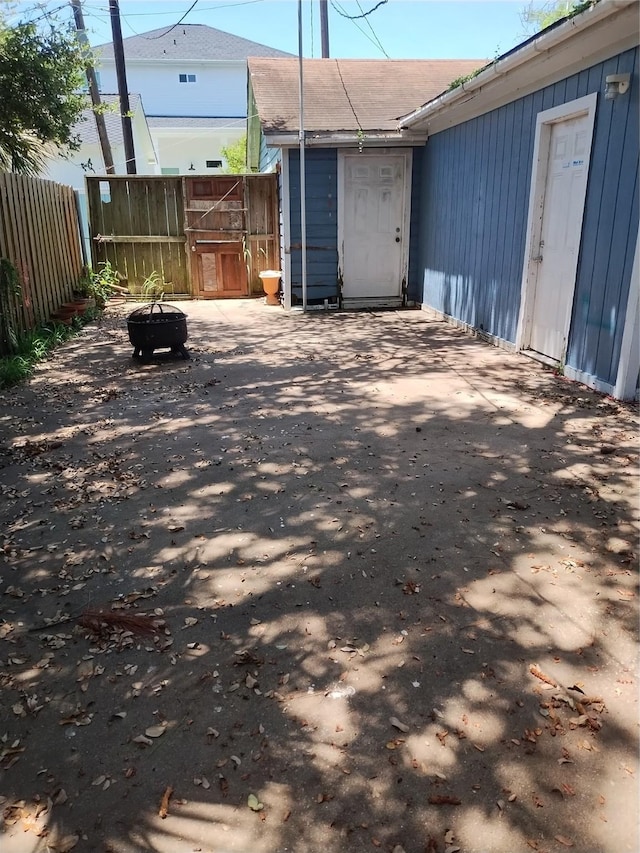 exterior space with a fire pit, fence, and a patio area