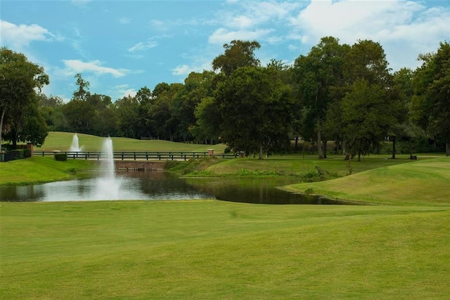 view of property's community featuring a yard and a water view