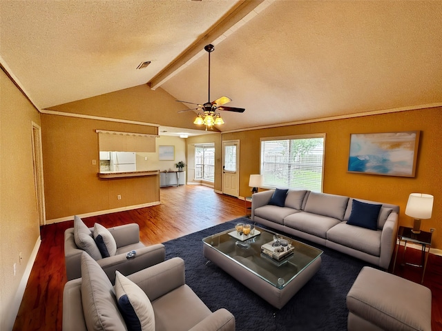 living room featuring a textured ceiling, wood-type flooring, ceiling fan, and vaulted ceiling with beams