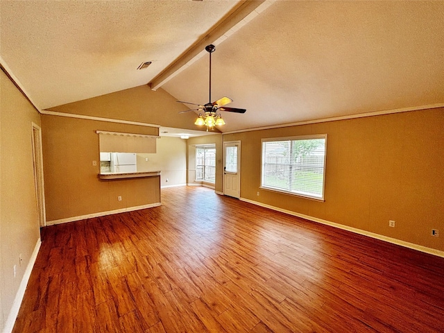 unfurnished living room featuring hardwood / wood-style floors, vaulted ceiling with beams, ceiling fan, crown molding, and a textured ceiling