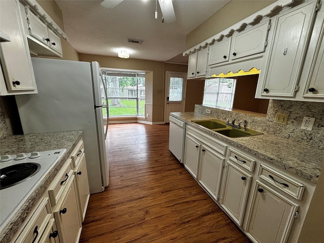 kitchen featuring white cabinets and white appliances