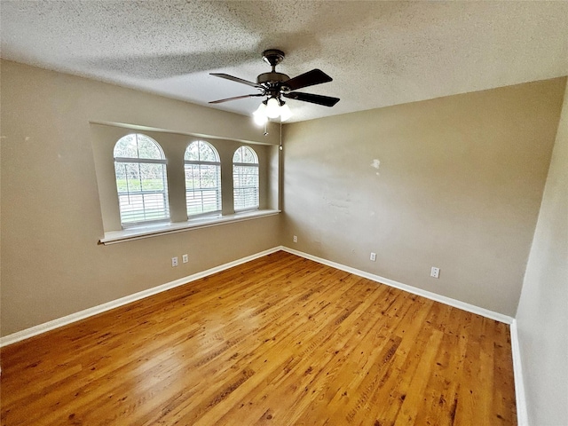 unfurnished room with hardwood / wood-style flooring, a textured ceiling, and ceiling fan