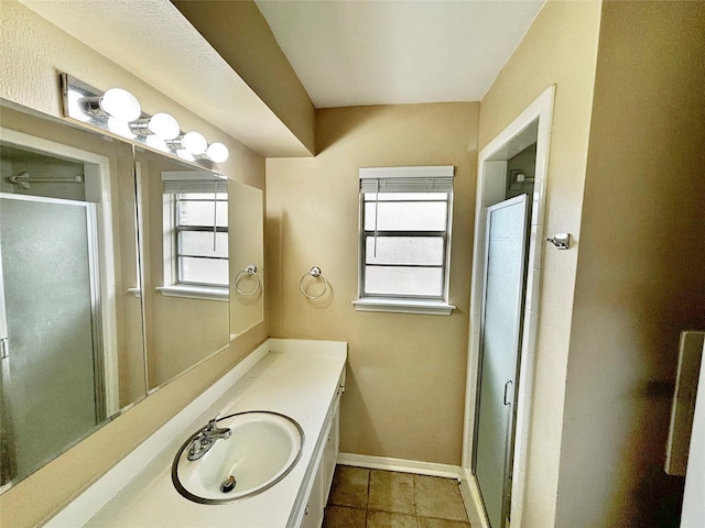 bathroom featuring vanity and an enclosed shower