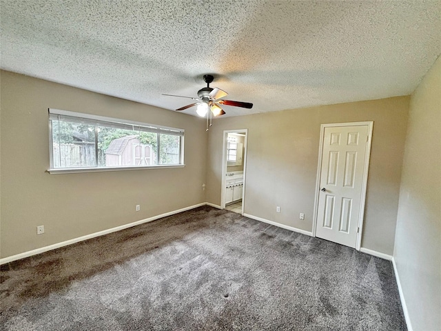 unfurnished bedroom featuring ensuite bathroom, carpet floors, a textured ceiling, and ceiling fan