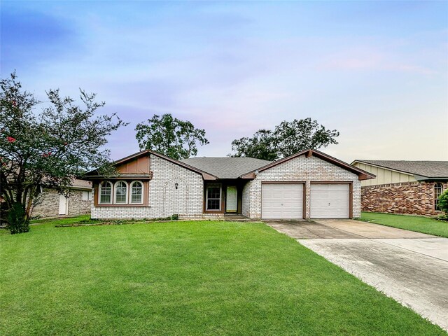 single story home with a front yard and a garage