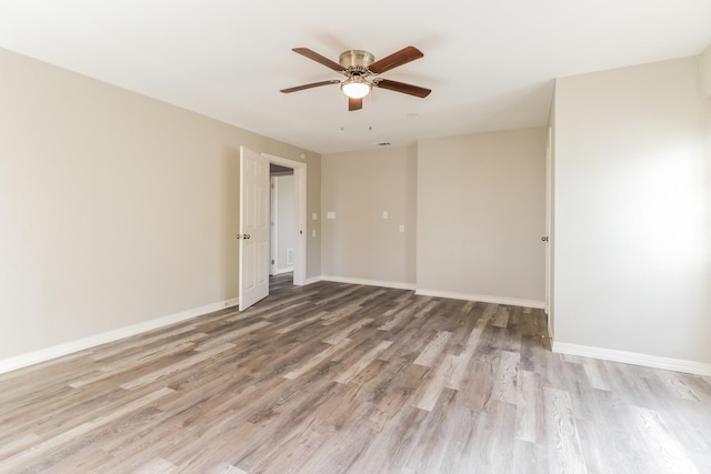 empty room with ceiling fan and light wood-type flooring