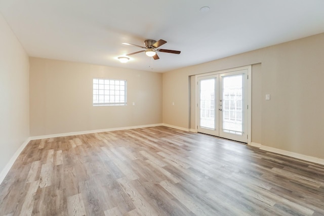 unfurnished room featuring ceiling fan, light hardwood / wood-style floors, and french doors