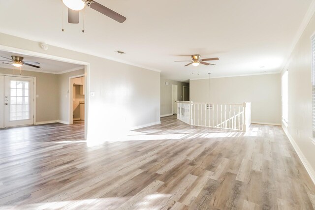 spare room featuring ceiling fan, light wood-type flooring, and crown molding