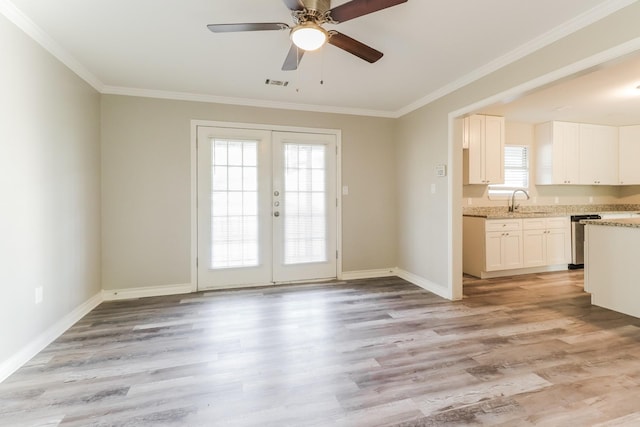 doorway to outside featuring light wood-type flooring, french doors, crown molding, and ceiling fan