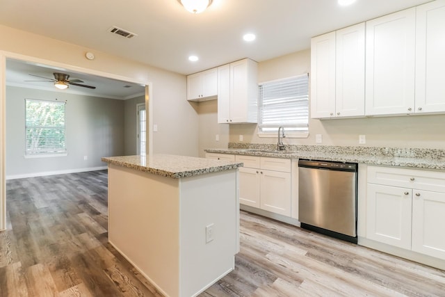 kitchen featuring ceiling fan, dishwasher, sink, white cabinetry, and light wood-type flooring