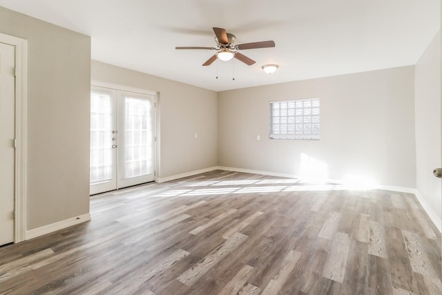 unfurnished room with ceiling fan, hardwood / wood-style floors, and french doors