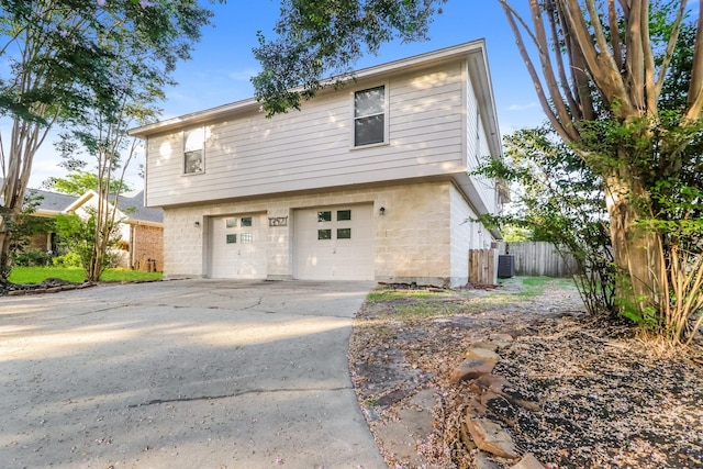 view of front of house with a garage and central AC