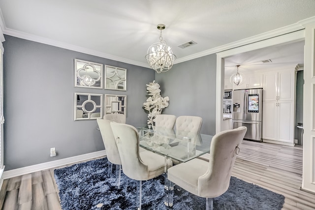 dining room with ornamental molding, a notable chandelier, and light hardwood / wood-style flooring