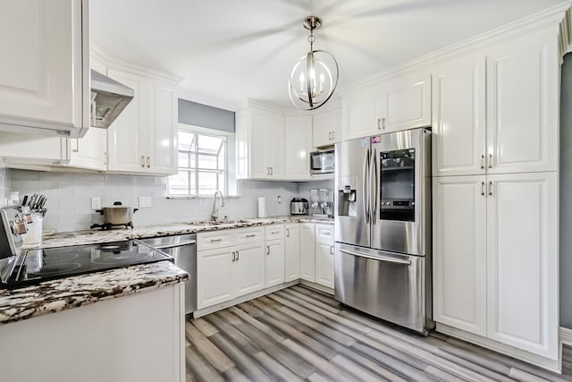 kitchen with hanging light fixtures, stainless steel appliances, sink, white cabinetry, and light wood-type flooring