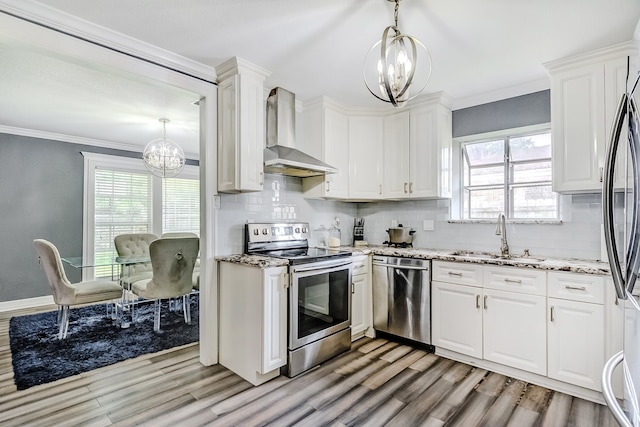 kitchen featuring appliances with stainless steel finishes, a chandelier, sink, and white cabinets