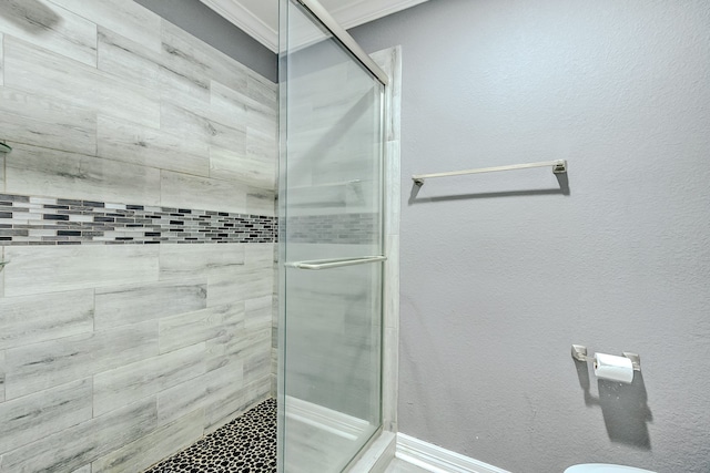 bathroom featuring walk in shower and ornamental molding