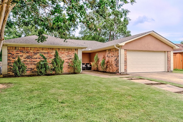 single story home with a garage and a front lawn