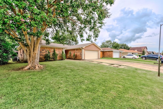 single story home featuring a garage, a front yard, and central AC