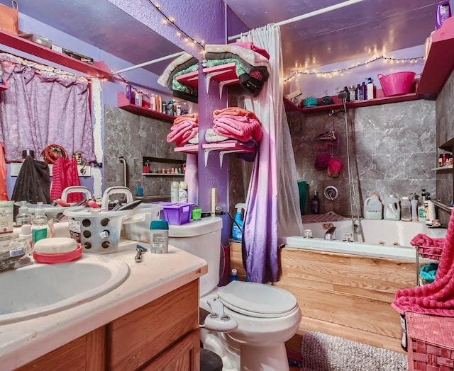 bathroom with tile walls, toilet, and vanity