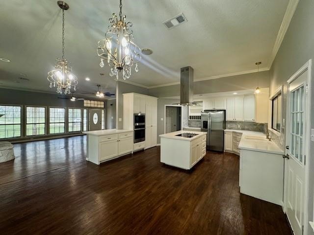 kitchen featuring stainless steel appliances, decorative light fixtures, and dark hardwood / wood-style flooring