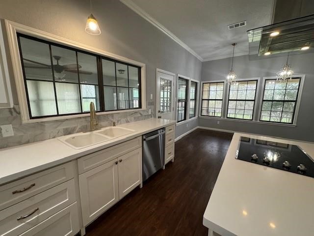 kitchen featuring hanging light fixtures, dark hardwood / wood-style flooring, sink, dishwasher, and backsplash