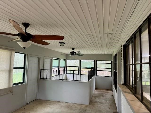 unfurnished sunroom with ceiling fan