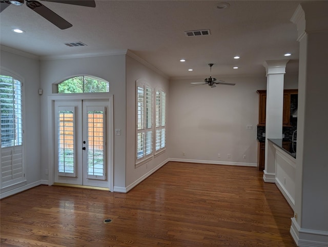 entryway with crown molding, plenty of natural light, and dark hardwood / wood-style floors