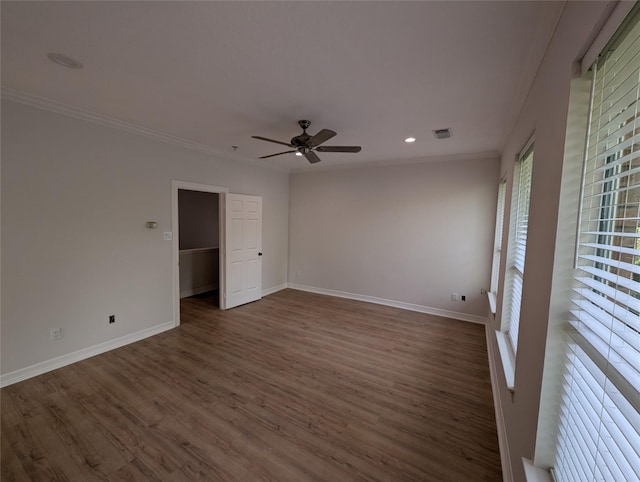 unfurnished room with dark wood-type flooring, ornamental molding, and ceiling fan