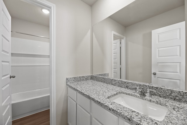 bathroom with shower / tub combination, vanity, and hardwood / wood-style flooring