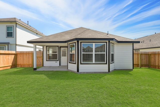 rear view of property featuring a yard and a patio