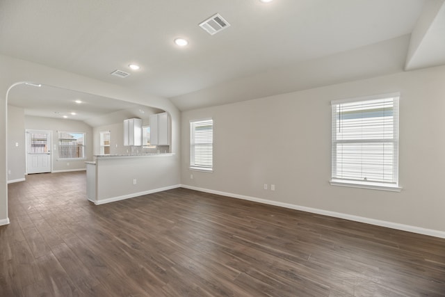 unfurnished living room with lofted ceiling, dark hardwood / wood-style flooring, and plenty of natural light