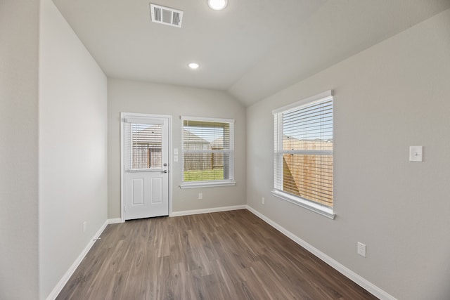 empty room with dark hardwood / wood-style floors and lofted ceiling