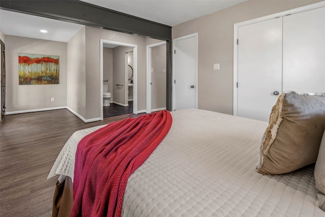 bedroom featuring dark wood-type flooring, a closet, and connected bathroom