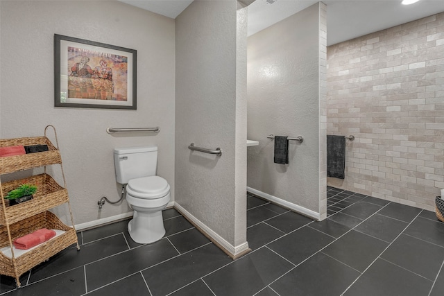 bathroom with toilet and tile patterned floors