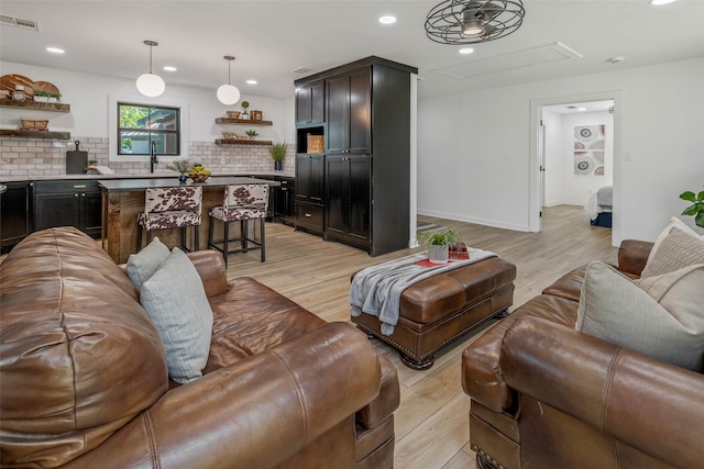 living room featuring light hardwood / wood-style flooring and sink