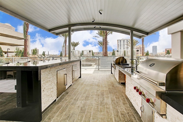 view of patio with area for grilling and a grill