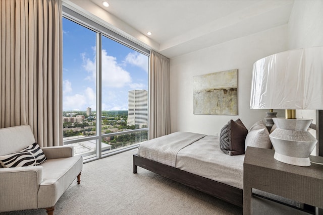 carpeted bedroom featuring multiple windows