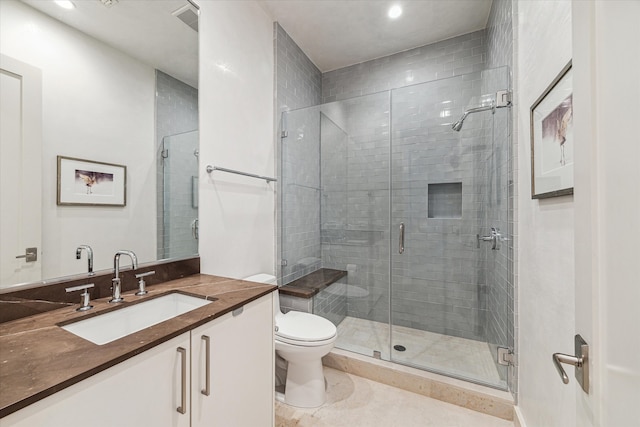 bathroom featuring walk in shower, vanity, and toilet