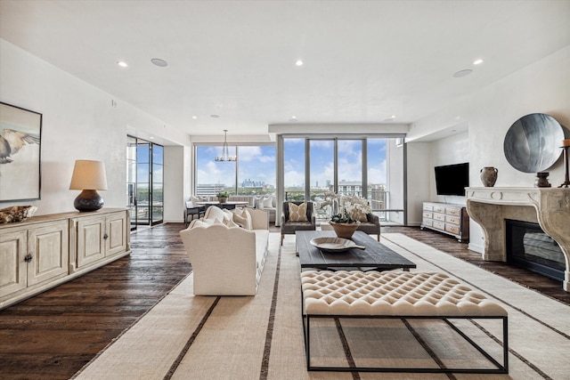 living room with a wall of windows, dark hardwood / wood-style flooring, and a high end fireplace