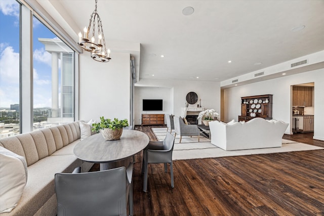 dining space with an inviting chandelier and hardwood / wood-style flooring