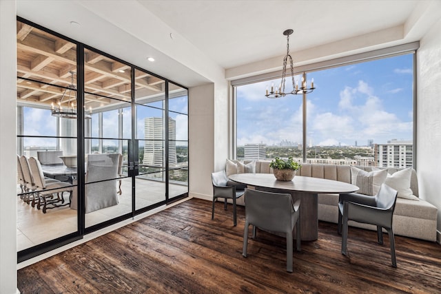 dining room with hardwood / wood-style flooring and a chandelier