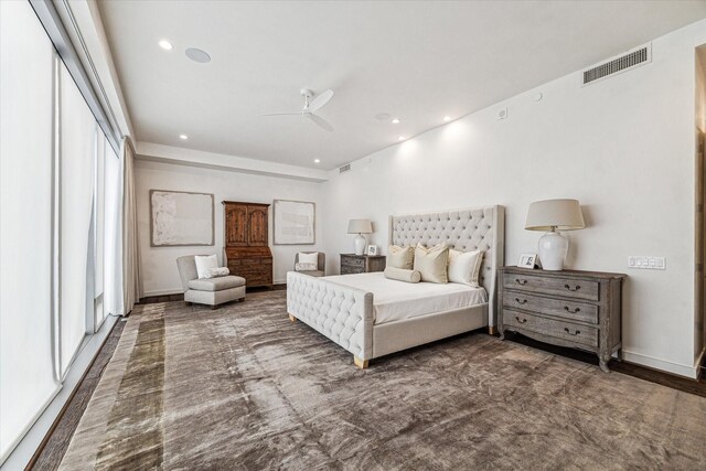 bedroom featuring multiple windows, ceiling fan, and dark hardwood / wood-style flooring