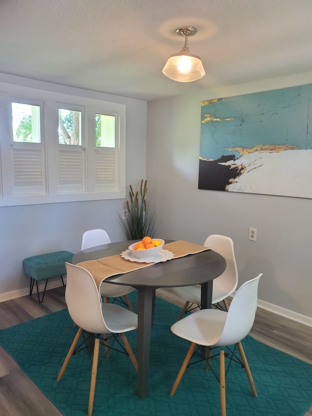 dining room featuring plenty of natural light and wood-type flooring