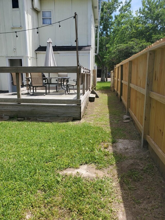 view of yard with a wooden deck