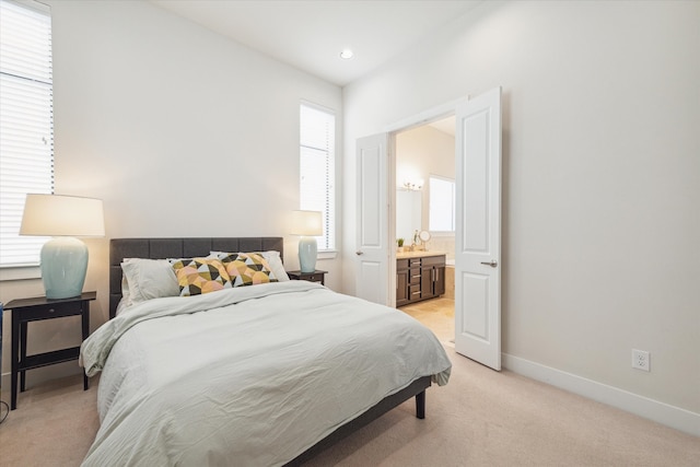 carpeted bedroom with ensuite bath