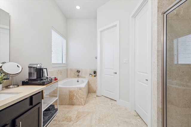 bathroom featuring tile patterned flooring, shower with separate bathtub, and vanity