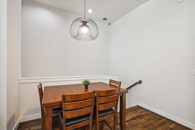 dining area with dark hardwood / wood-style flooring and lofted ceiling