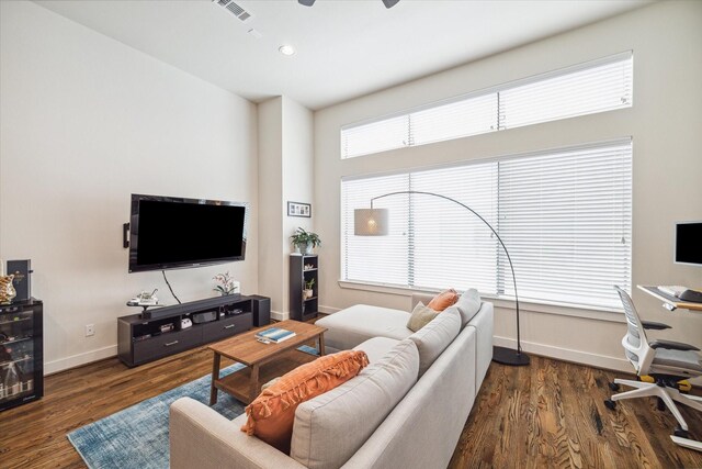 living room with dark hardwood / wood-style floors and ceiling fan