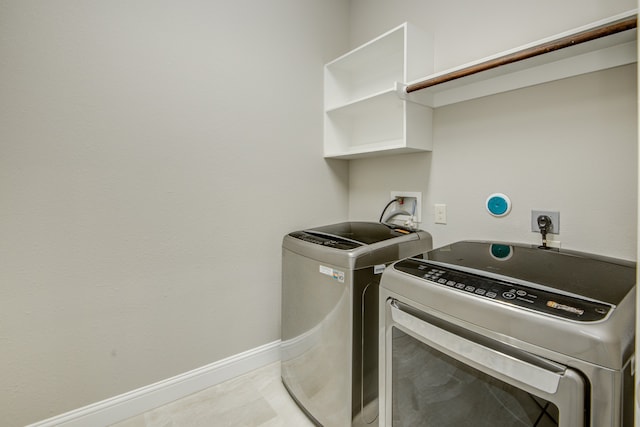 laundry area featuring light tile patterned flooring and independent washer and dryer