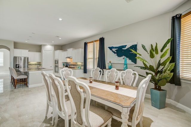 dining area featuring light tile patterned flooring and a healthy amount of sunlight